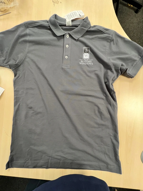 Front of grey polo shirt with Bespoke Windows logo printed left chest — branded workwear by Furnival Press, South Essex