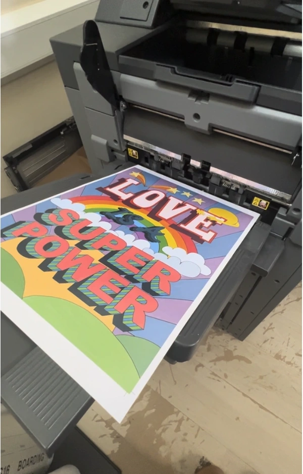 "Love Superpower" art print coming off the press
