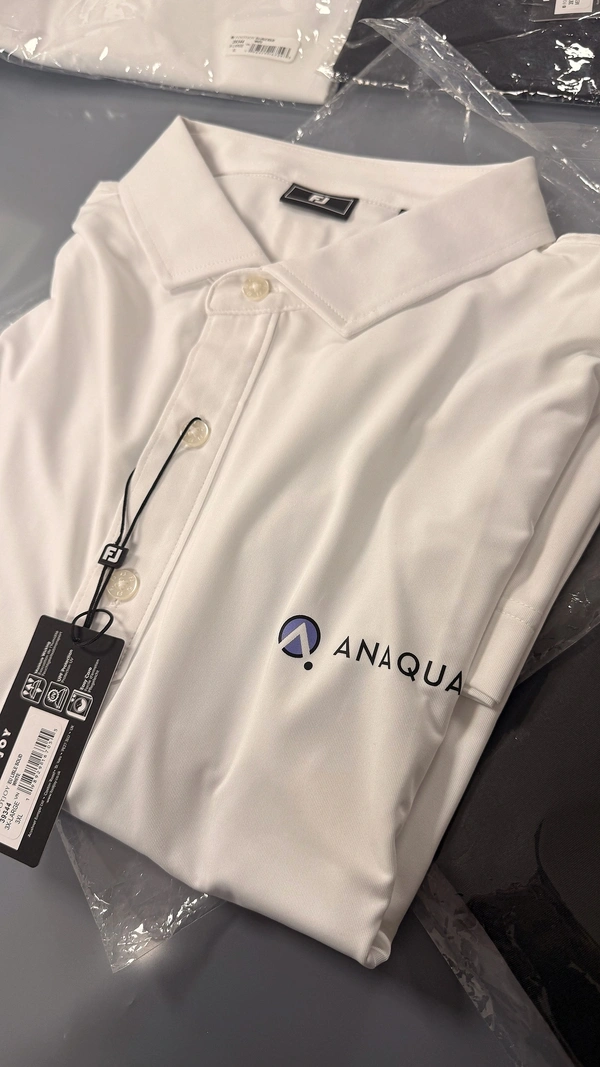 Custom printed FootJoy polo shirt with Anaqua logo — premium branded corporate clothing for London events and golf days by Furnival Press